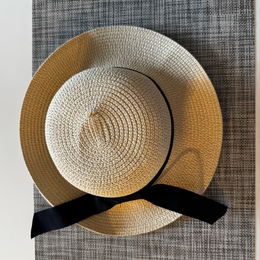 Kids Straw Hat with black bow; adjustable inner band and removable strap.